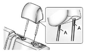 1. Insert the head restraint posts into the holes in the top of the seatback.