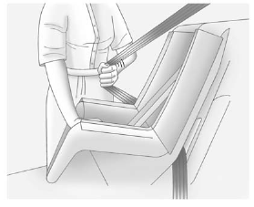 4. Pull the shoulder belt all the way out of the retractor to set the lock. When