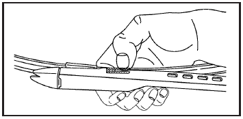 3. Squeeze the tabs on each side of the wiper blade