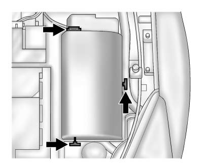 To remove the fuse block cover, press the three retaining clips on the cover and lift it straight up.